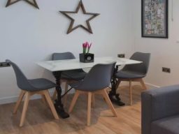 Blackbird Luxury Accommodation Suite 7 Modern bedroom featuring a large double bed with patterned headboard and stylish décor.