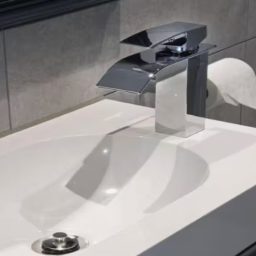 Blackbird Luxury Accommodation Suite 7 Modern kitchen featuring grey cabinetry, a sink, microwave, and kettle.